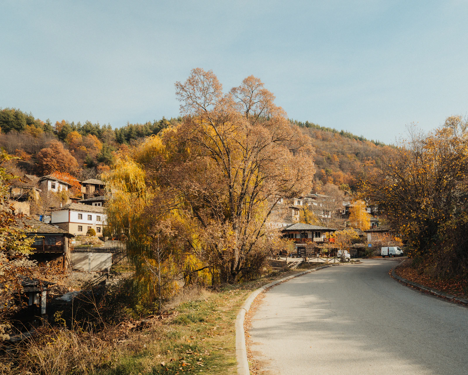 Houses and a winding rural road through Leshten, Bulgaria